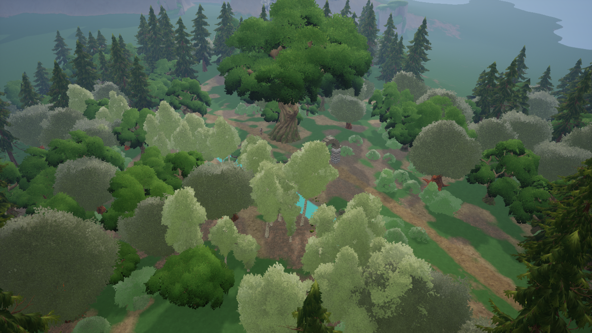 A wide view of forested hills, mountains and a distant lake